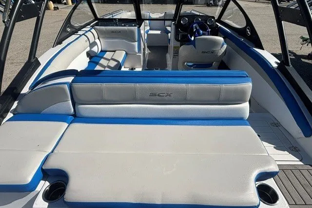 Slide: The Image of 2017 Starcraft SCX Surf 211 IO boat interior with blue and white seating. - 8