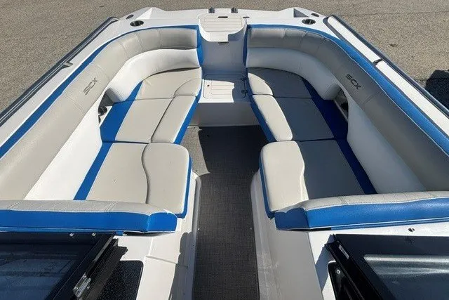 Slide: The Image of 2017 Starcraft SCX Surf 211 IO boat interior with spacious seating and blue accents. - 9