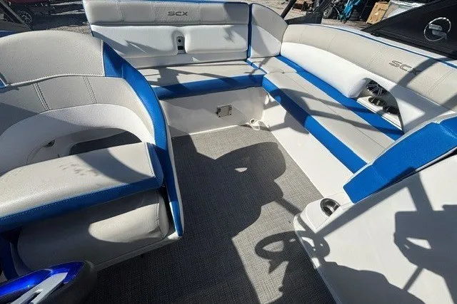 Slide: The Image of 2017 Starcraft SCX Surf 211 IO boat interior with blue and white seating. - 10