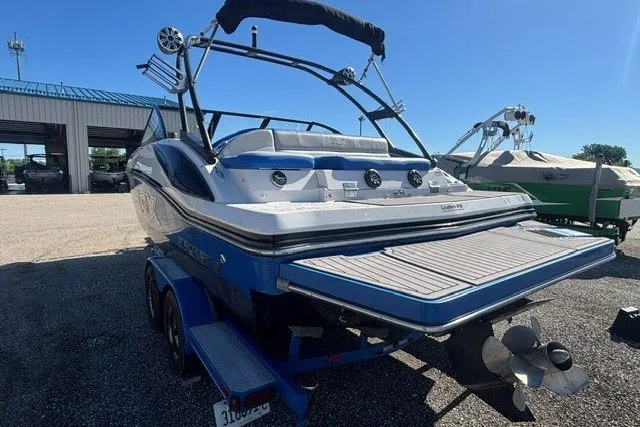 Slide: The Image of 2017 Starcraft SCX Surf 211 IO boat on trailer, rear view, sunny day. - 12
