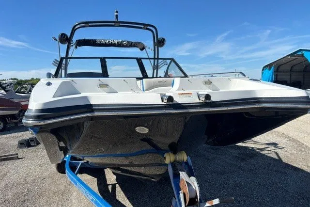 Slide: The Image of 2017 Starcraft SCX Surf 211 IO boat on trailer, parked outdoors. - 17