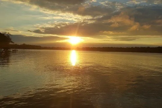 Slide: The Image of Sunset over a tranquil lake, reflecting golden hues on the water's surface. - 19