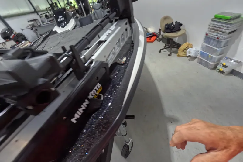 Slide: The Image of 2026 Skeeter ZXR21 SE boat with Minn Kota trolling motor in a garage setting. - 9