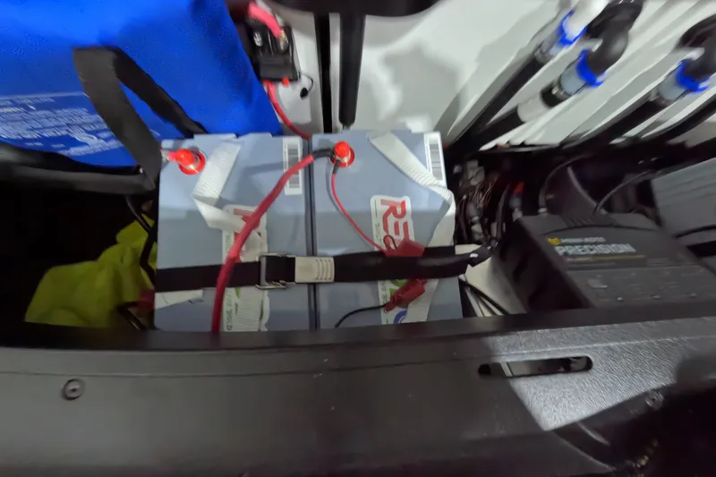 Slide: The Image of Battery compartment of a 2026 Skeeter ZXR21 SE with wiring and components visible. - 21