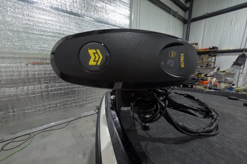 Slide: The Image of 2026 Skeeter ZXR21 SE boat with Ultrex trolling motor in a garage setting. - 10