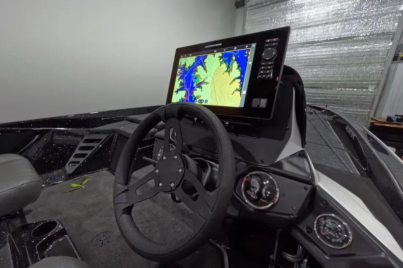 Slide: The Image of Interior of 2026 Skeeter ZXR21 SE boat with advanced navigation system and steering wheel. - 2