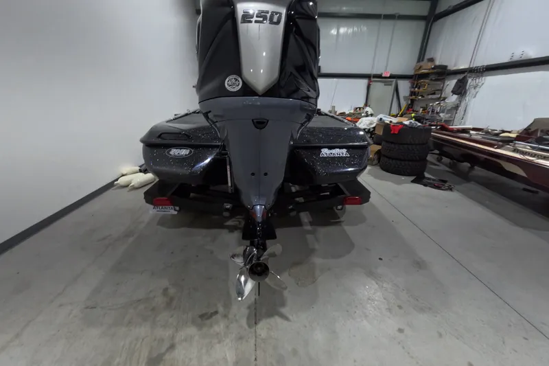 Slide: The Image of 2026 Skeeter ZXR21 SE boat in a garage, rear view with motor and propeller. - 19