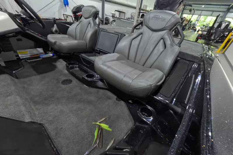 Slide: The Image of Interior of 2026 Skeeter ZXR21 SE boat with gray seats and carpeted flooring. - 12