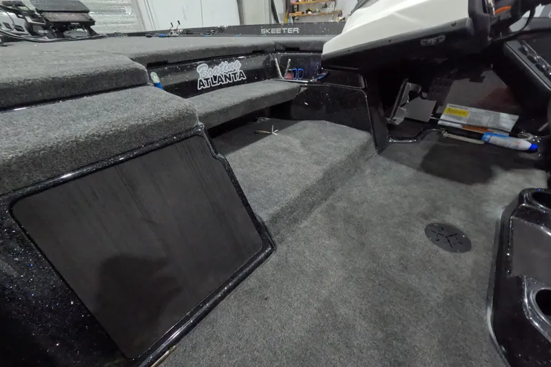 Slide: The Image of 2026 Skeeter ZXR21 SE boat interior with carpeted flooring and storage compartments. - 13
