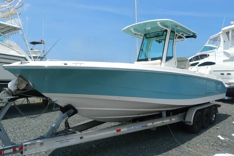 The Image of 2027 Boston Whaler 280 Dauntless boat on trailer, displayed outdoors under clear blue sky. - 0
