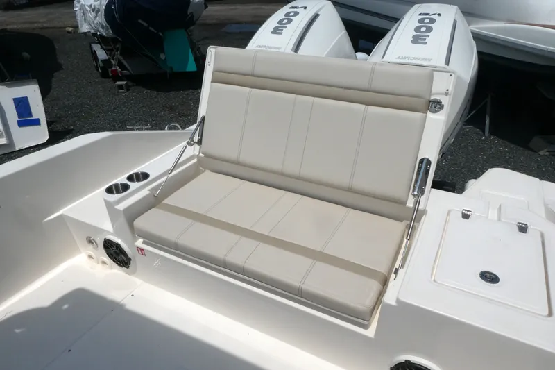 Slide: The Image of 2027 Boston Whaler 280 Dauntless boat seating area with cup holders and dual Mercury engines. - 6