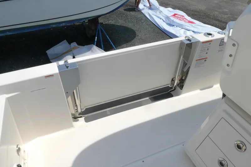 Slide: The Image of 2027 Boston Whaler 280 Dauntless boat interior, featuring a sleek, modern design and storage compartments. - 17