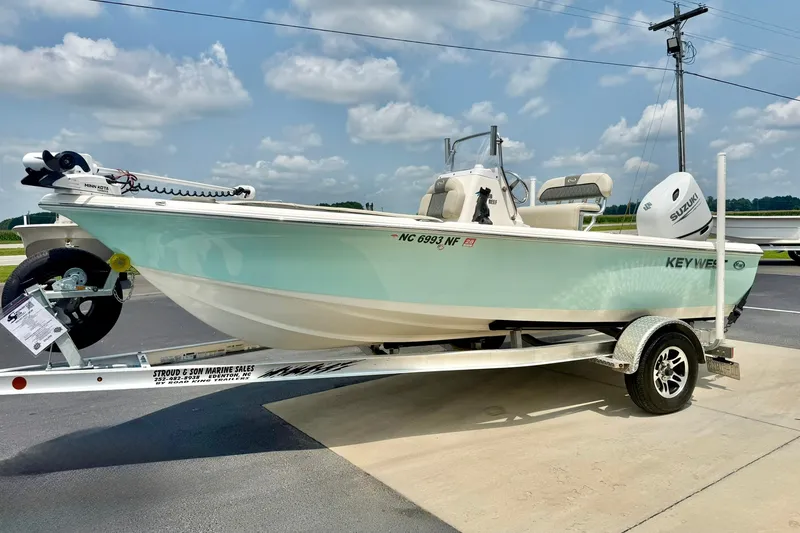 Slide: The Image of 2025 Key West 188 Bay Reef boat on trailer, displayed outdoors under a cloudy sky. - 5