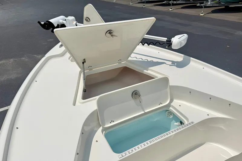 Slide: The Image of 2025 Key West 188 Bay Reef boat deck with open storage compartments and trolling motor. - 12