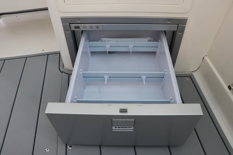 Slide: The Image of Open storage drawer on 2026 Chaparral 280 OSX boat, showcasing interior compartments. - 20