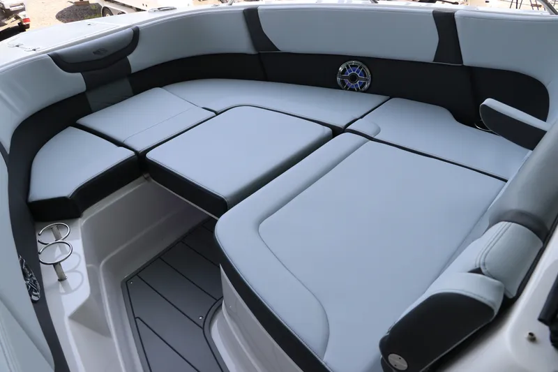 Slide: The Image of 2026 Chaparral 280 OSX boat interior with cushioned seating and cup holders. - 39