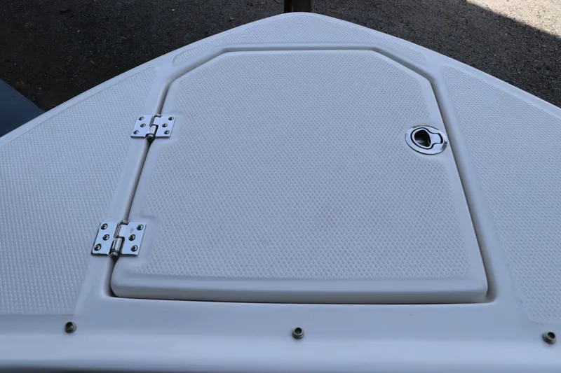 Slide: The Image of 2026 Chaparral 280 OSX boat deck hatch with textured surface and metal hinges. - 43