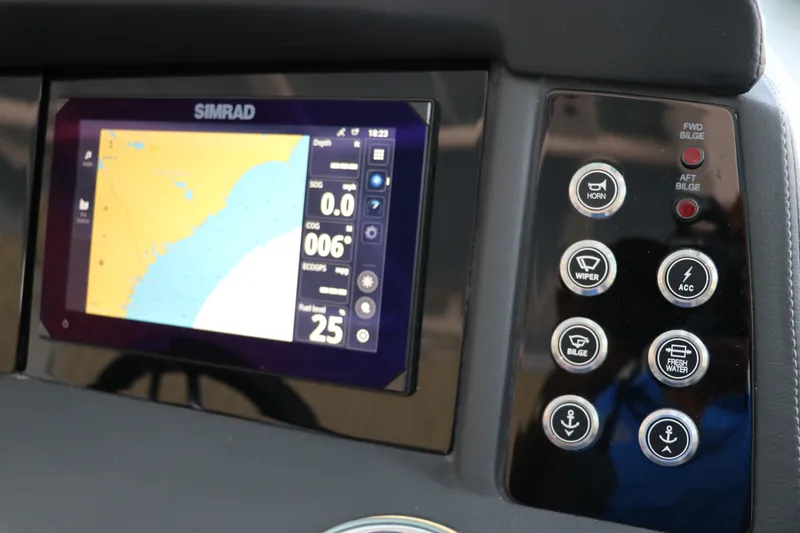 Slide: The Image of Dashboard of 2026 Chaparral 280 OSX with Simrad navigation display and control buttons. - 27