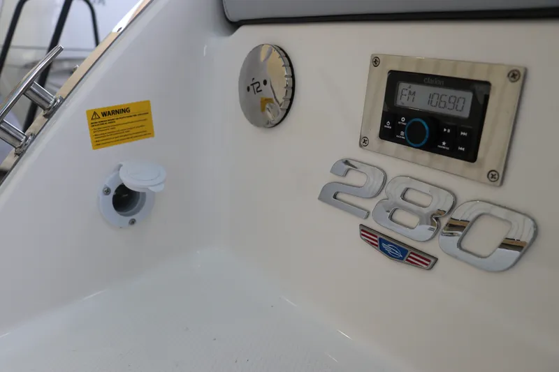 Slide: The Image of Control panel of 2026 Chaparral 280 OSX boat with radio and warning label. - 8