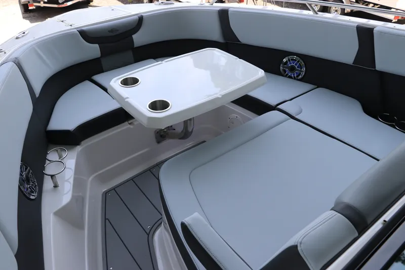 Slide: The Image of 2026 Chaparral 280 OSX boat interior with cushioned seating and table. - 42