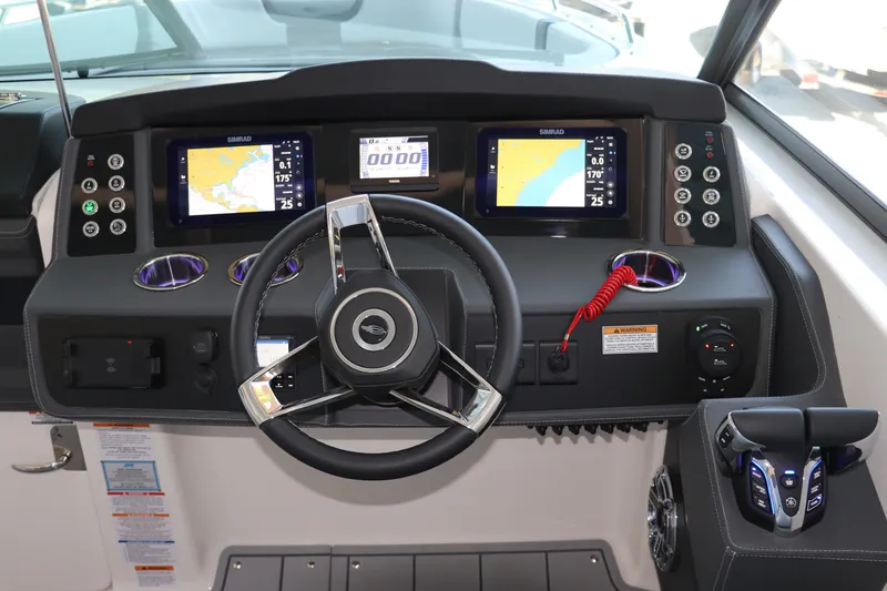 Slide: The Image of 2026 Chaparral 280 OSX helm with dual Simrad displays and modern controls. - 23