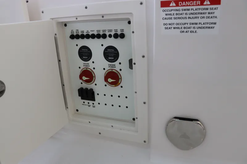 Slide: The Image of Electrical panel on 2026 Chaparral 280 OSX boat with safety warning label. - 10