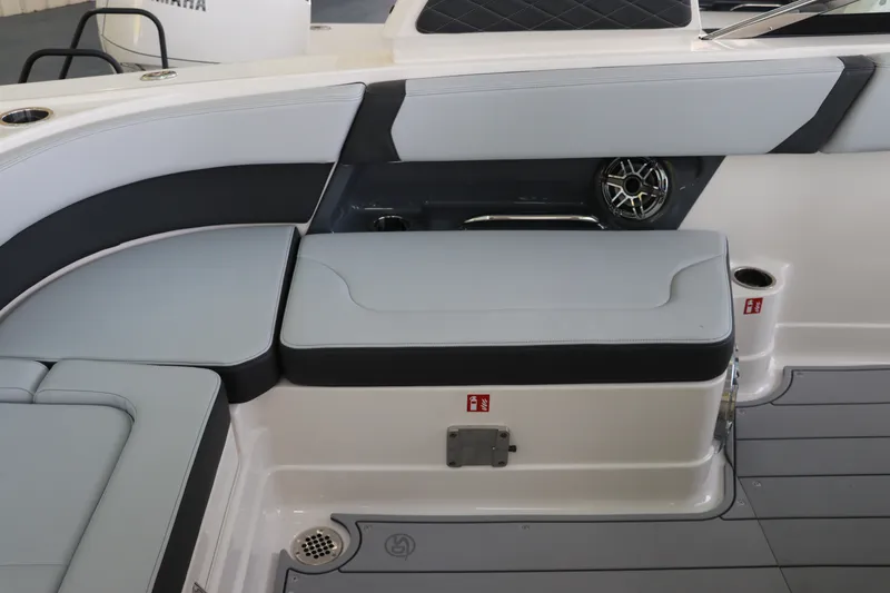 Slide: The Image of 2026 Chaparral 280 OSX boat interior with cushioned seating and speaker system. - 13