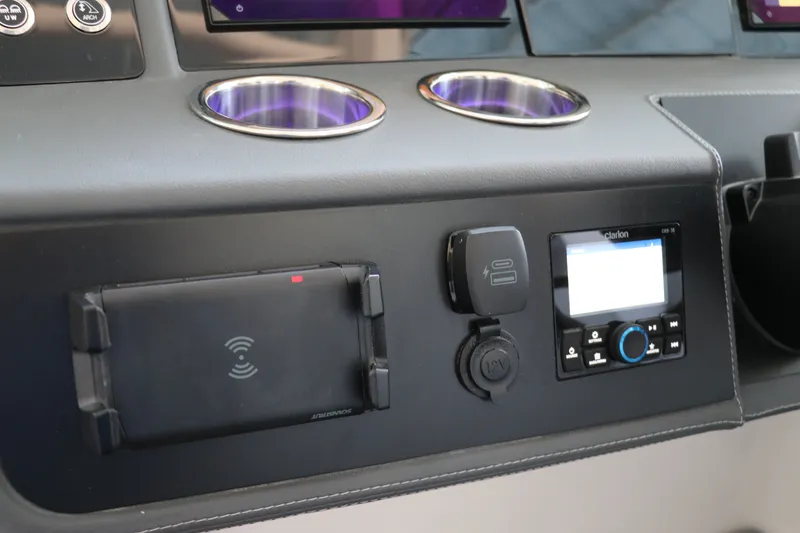 Slide: The Image of Dashboard of 2026 Chaparral 280 OSX featuring cup holders and electronic controls. - 25