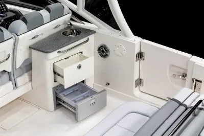 Slide: The Image of 2026 Chaparral 280 OSX boat interior with storage drawers and seating. - 8