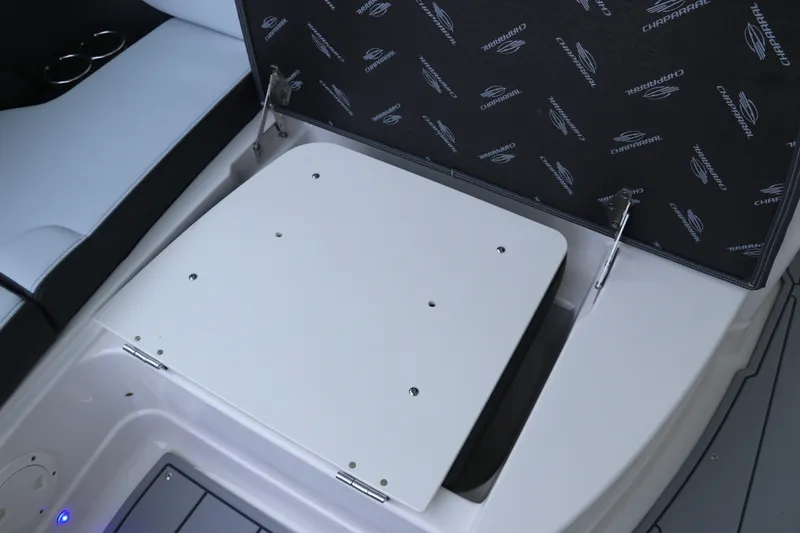 Slide: The Image of 2026 Chaparral 280 OSX boat storage compartment with open lid and branded interior. - 37