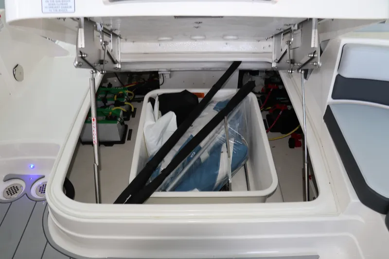Slide: The Image of Storage compartment of 2026 Chaparral 280 OSX boat, featuring organized equipment and batteries. - 12