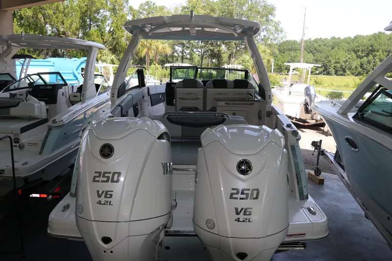 Slide: The Image of The image shows a 2026 Chaparral 280 OSX boat with two powerful outboard engines. - 3