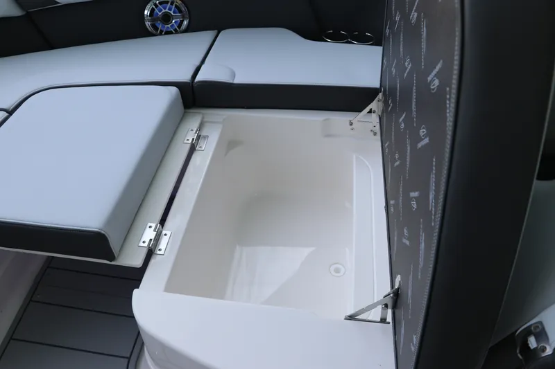 Slide: The Image of 2026 Chaparral 280 OSX boat interior storage compartment with cushioned seating. - 38