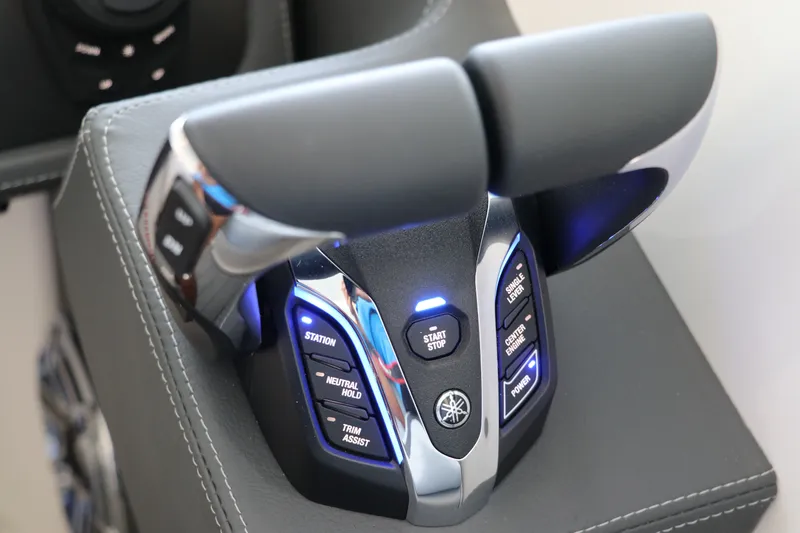 Slide: The Image of Throttle controls of the 2026 Chaparral 280 OSX boat with illuminated buttons. - 29