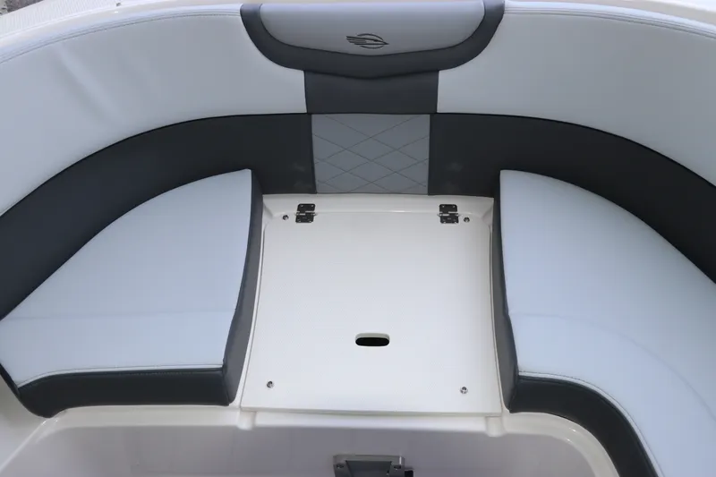 Slide: The Image of 2026 Chaparral 280 OSX boat seating area with sleek, modern design and storage compartment. - 40