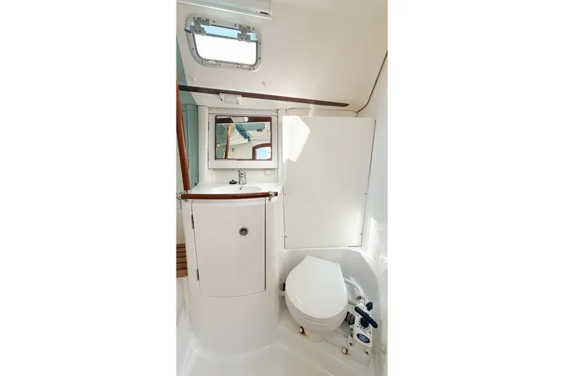 Slide: The Image of Bathroom interior of 2002 Beneteau 361 yacht, featuring sink, mirror, and toilet. - 26