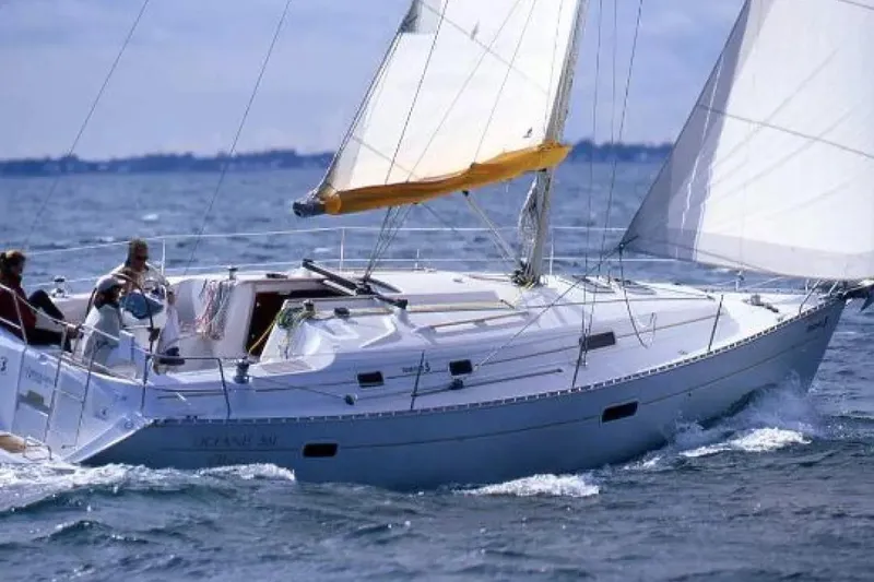 Slide: The Image of 2002 Beneteau Oceanis 361 sailboat navigating on open water with full sails. - 3