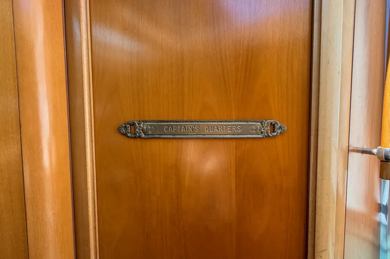 Slide: The Image of Wooden door with "Captain's Quarters" plaque on a 2002 Beneteau 361 yacht. - 18