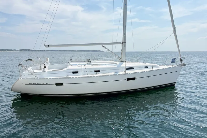 The Image of A 2002 Beneteau 361 sailing on calm waters under a blue sky. - 0
