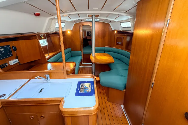 Slide: The Image of Interior of 2002 Beneteau 361 yacht with wood finish and green seating. - 15