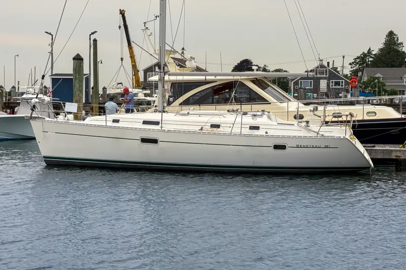 The Image of 2002 Beneteau Oceanis 361 sailboat docked at a marina, side view. - 1