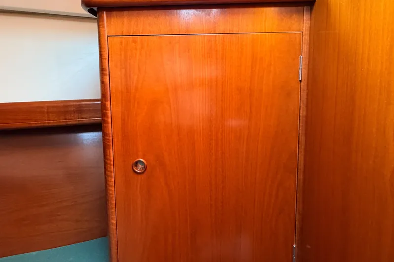 Slide: The Image of Wooden cabinet door inside a 2002 Beneteau 361 sailboat interior. - 23