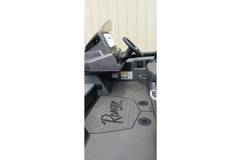 Slide: The Image of Interior of 2025 Ranger ALPHA 208 boat with steering wheel and branded flooring. - 10