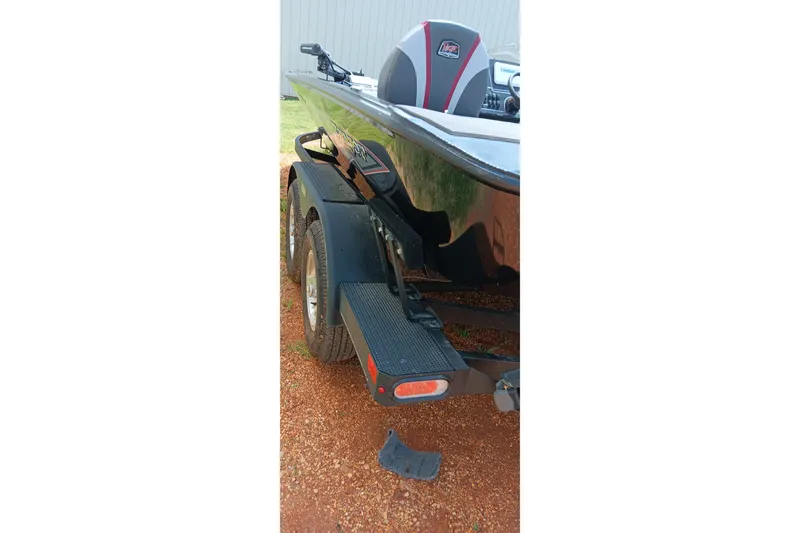 Slide: The Image of 2025 Ranger ALPHA 208 boat on trailer, rear view with visible tires and step. - 4