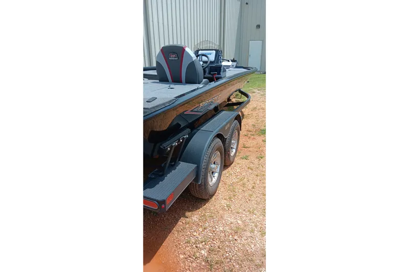 Slide: The Image of 2025 Ranger ALPHA 208 boat on trailer, parked outdoors near a building. - 5
