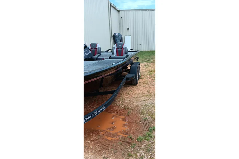Slide: The Image of 2025 Ranger ALPHA 208 boat on trailer near metal building. - 15