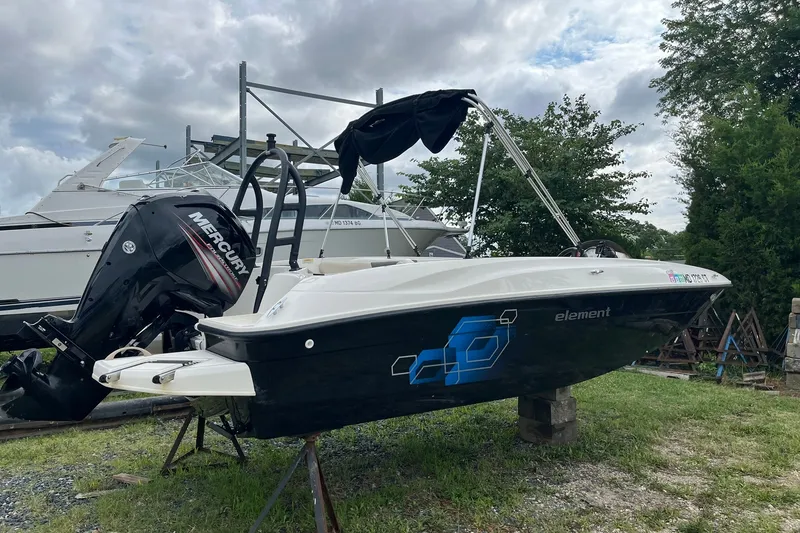 Slide: The Image of 2018 Bayliner Element E18 boat with Mercury outboard motor on display outdoors. - 3