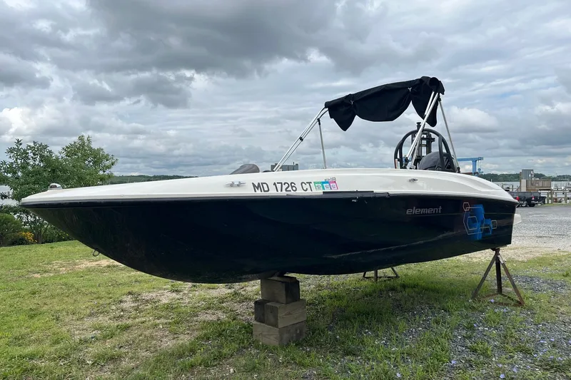 Slide: The Image of 2018 Bayliner Element E18 boat on stands, cloudy sky background. - 2