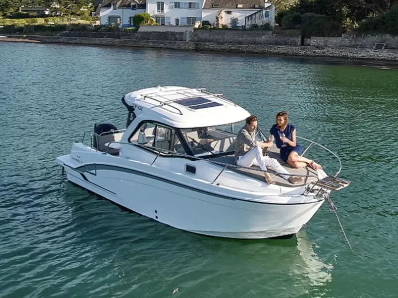 Slide: The Image of Manufacturer Provided Image: 2026 Beneteau Antares 7 boat on water with two people relaxing on deck. - 2