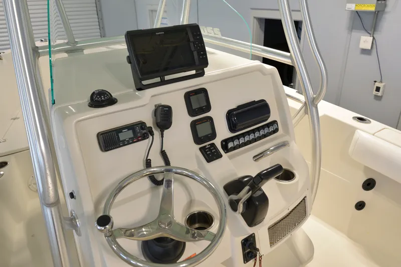 Slide: The Image of 2014 Sailfish 220 CC boat console with steering wheel, GPS, and communication devices. - 5